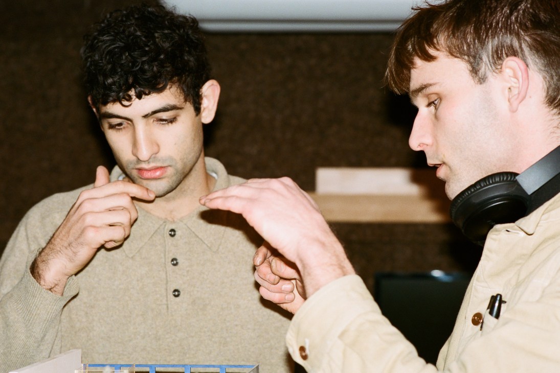 Two men brainstorming at Space10, one wearing headphones around his neck.