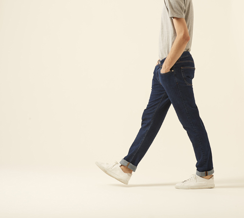 Person wearing Brooklyn denim by Blauer USA in dark blue with white sneakers and light shirt