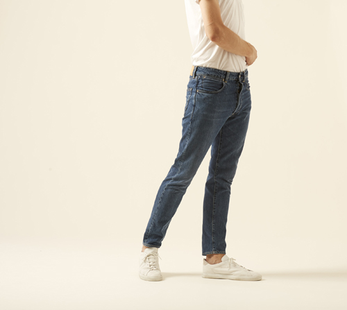 Woman wearing DP jeans by Golden Goose in dark blue with tailored fit and white sneakers