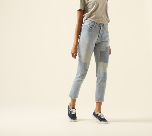 The Detroit jeans by Atelier & Repairs shown on model wearing beige shirt and navy sneakers.