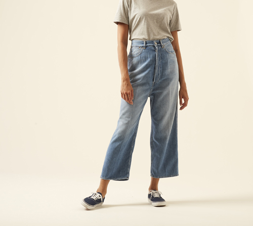 Woman wearing Breezy jeans by Golden Goose in light wash with distressed detailing and relaxed fit