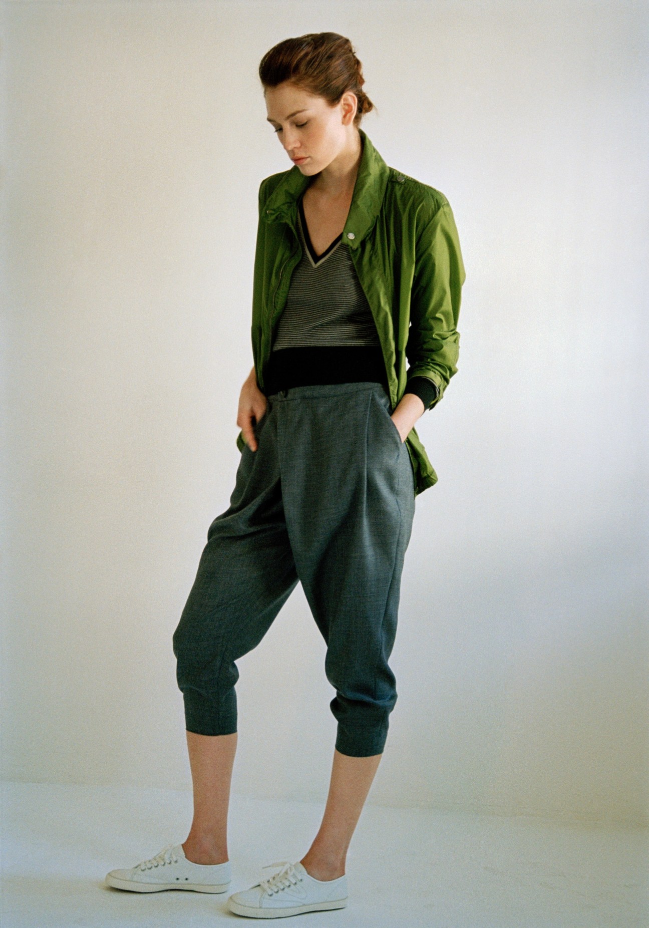 Model wearing green CP Company jacket, Bamford jumper, Knott Galerie Vie trousers and Tretorn shoes.