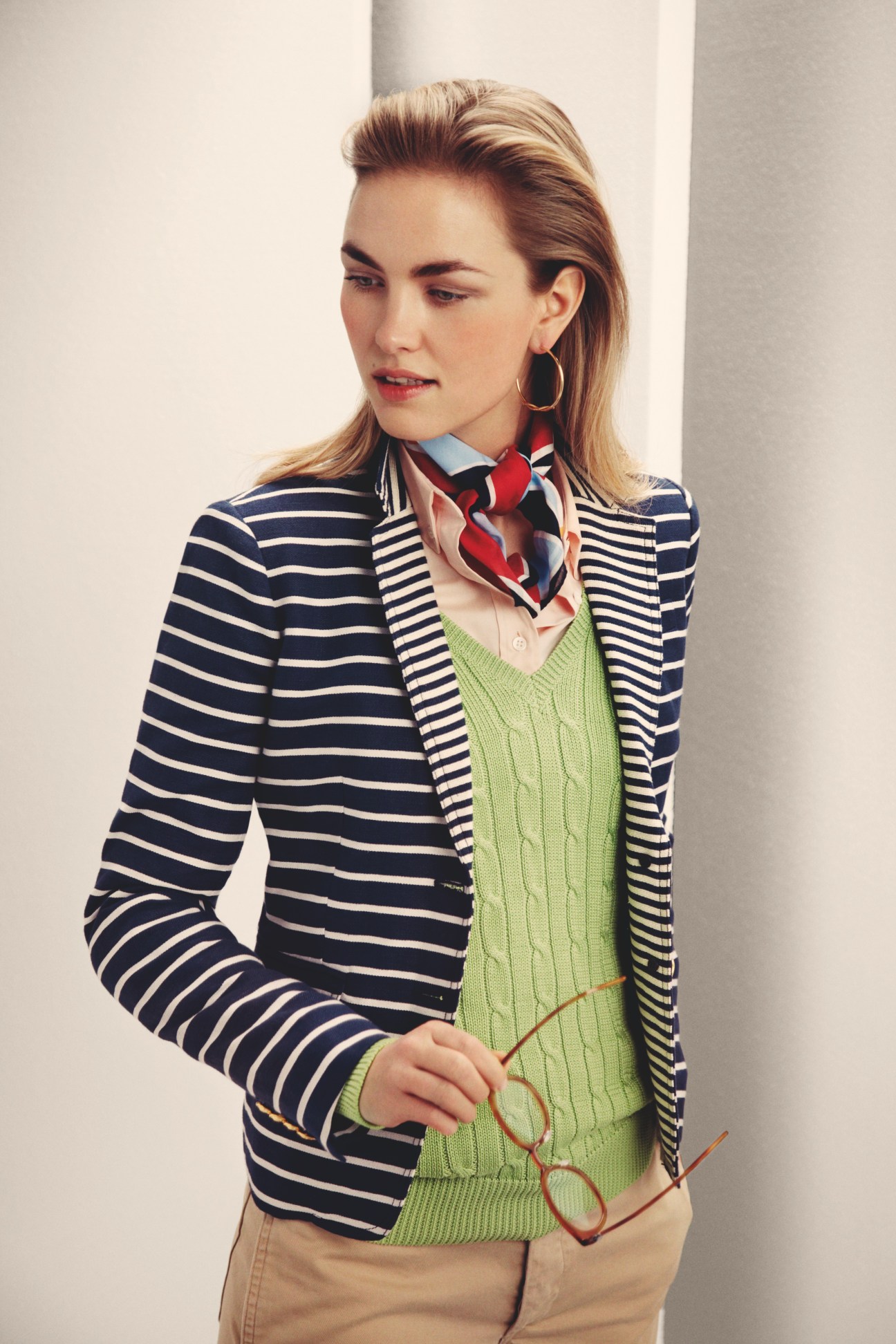 Woman wearing striped J.Crew jacket, green Ralph Lauren jumper, patterned scarf and Lindberg glasses.