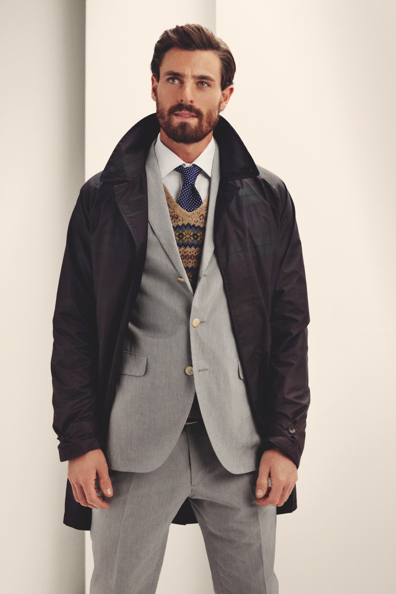 Man wearing layered spring outfit with Baracuta coat, Boglioli jacket and trousers, and patterned waistcoat.