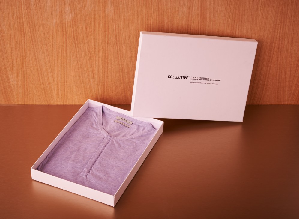 Collective organic cotton Henley shirt in lavender displayed in a pink branded box.