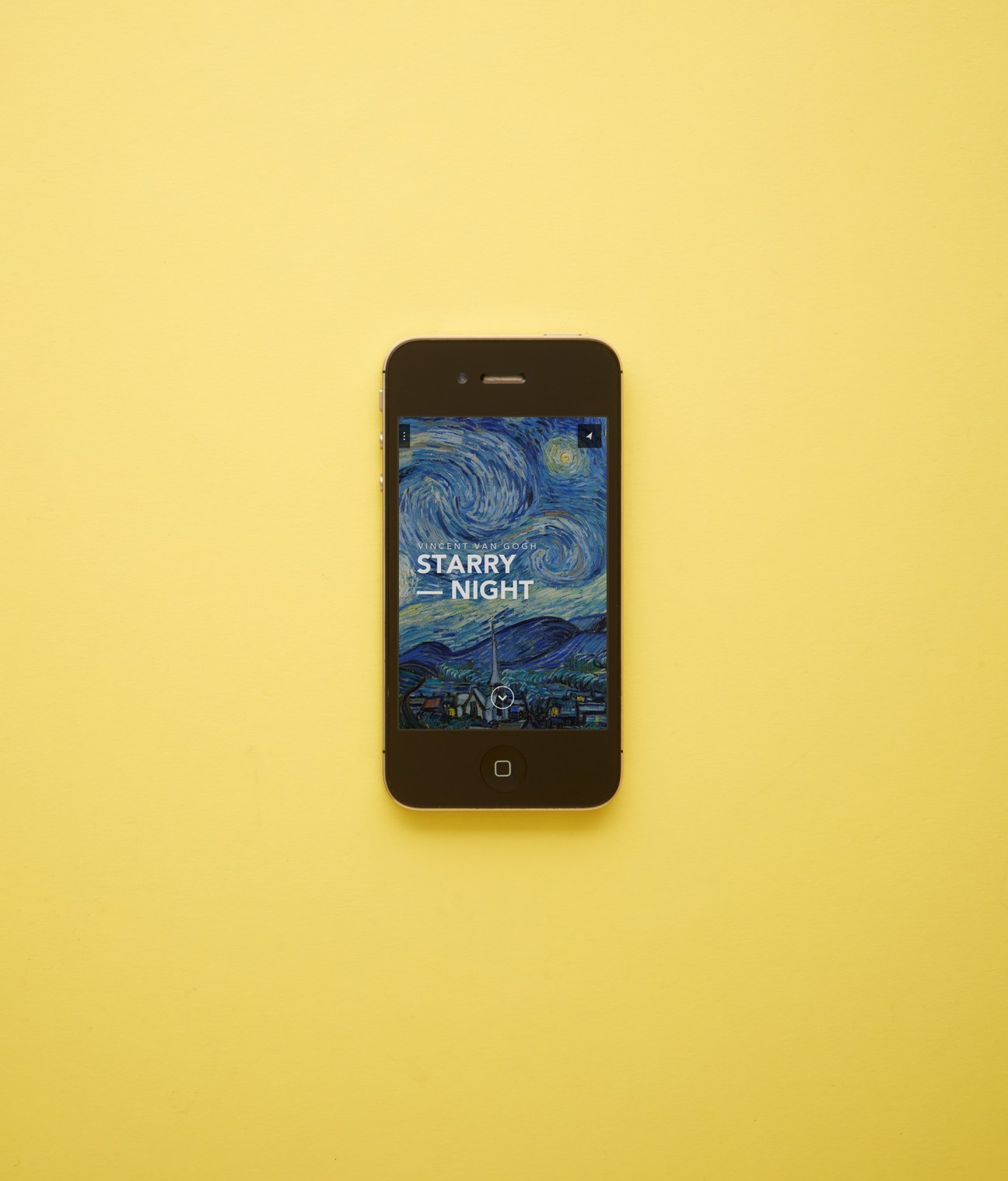 Black smartphone displaying Van Gogh's Starry Night artwork on yellow background.