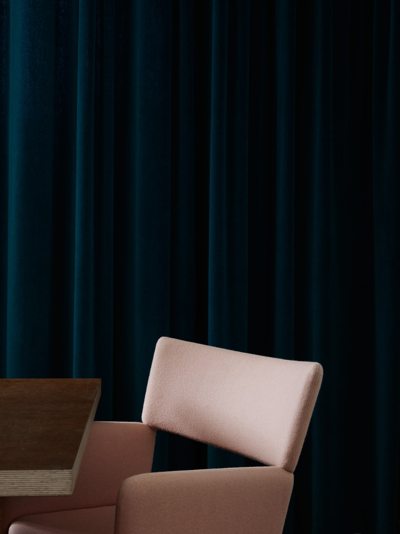 Crown Easy Chair by Massproductions in pink upholstery against dark blue curtains