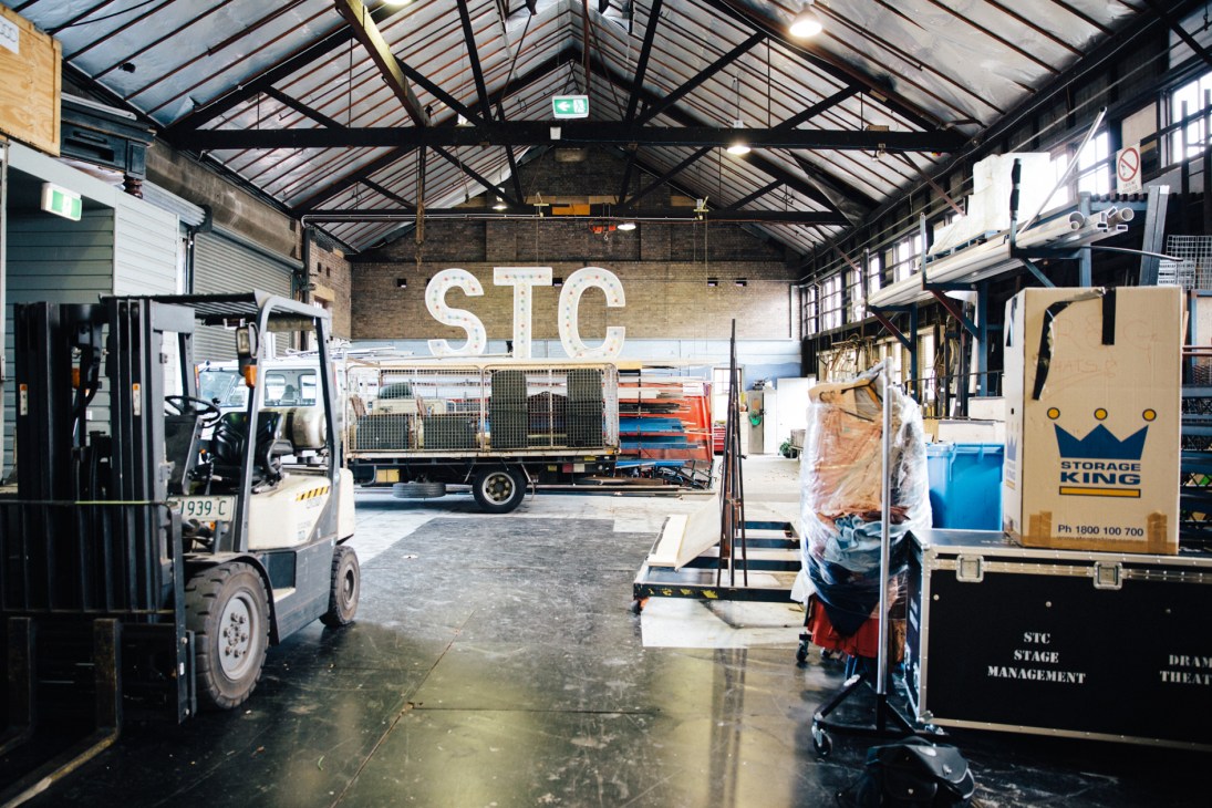 Sydney Theatre Company warehouse with STC signage, forklift, and stage management equipment.