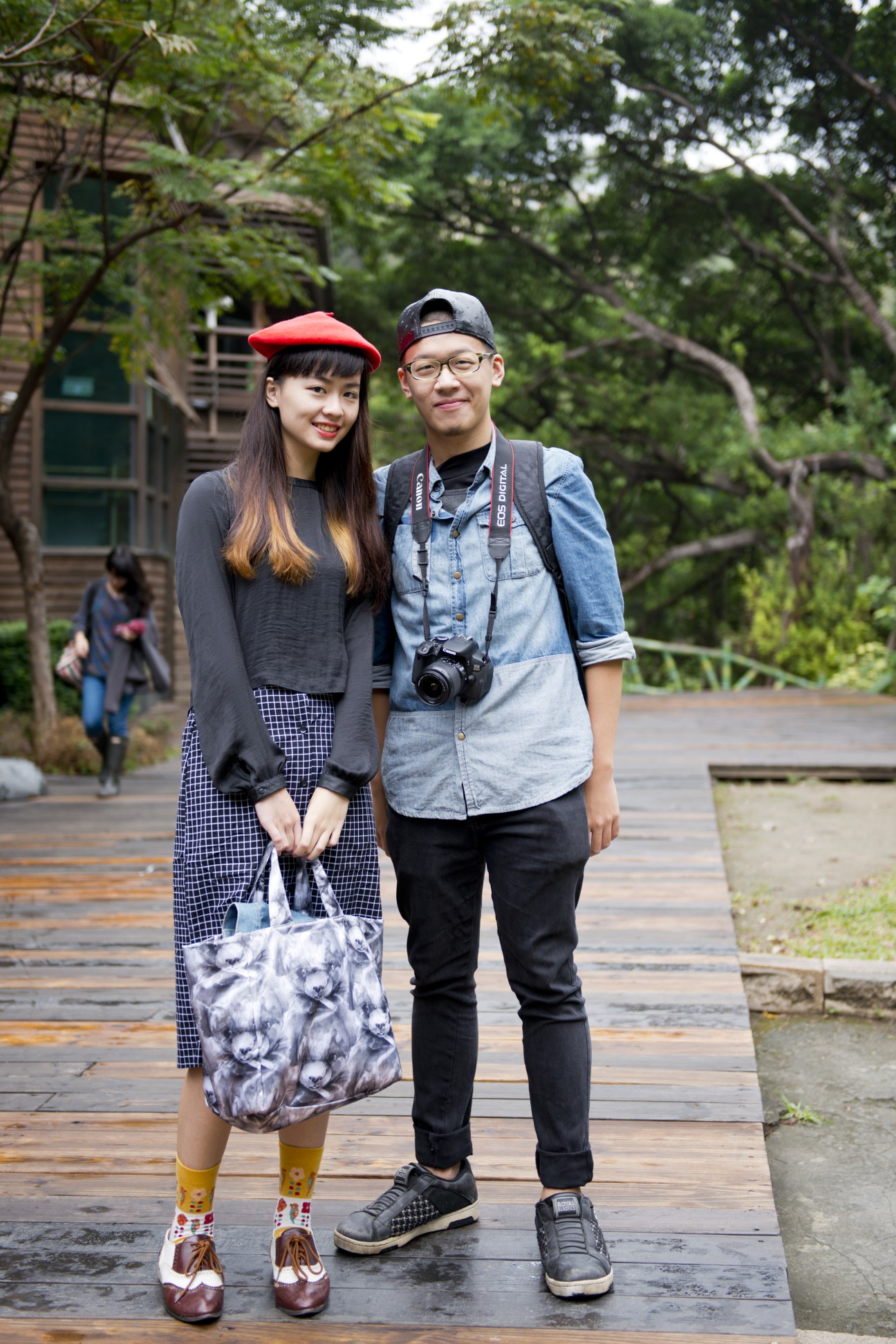 Couple posing in front of the eco-friendly Beitou Library surrounded by greenery.