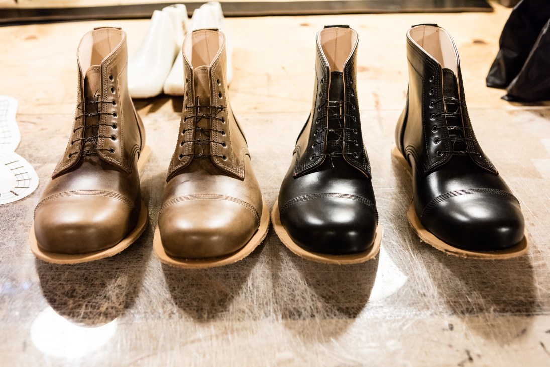 Four leather Ryaton boots in brown and black displayed on a polished floor