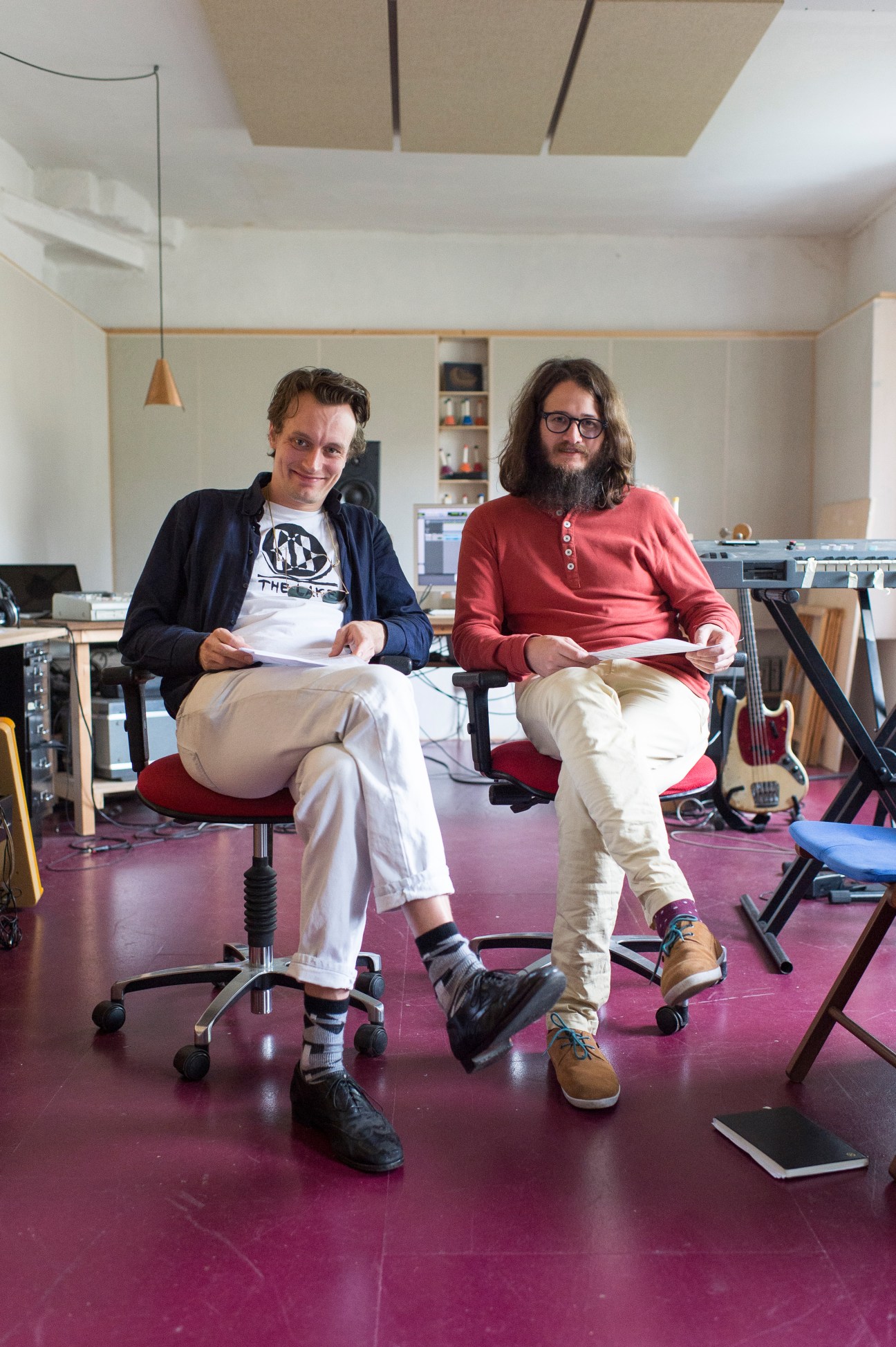 Casper Clausen and Mads Brauer from Efterklang sit in their Berlin studio surrounded by instruments and equipment.