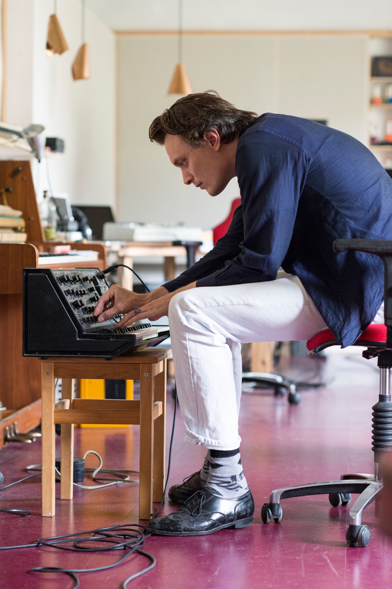 Casper Clausen of Efterklang works at a synthesizer in the band's Berlin studio.