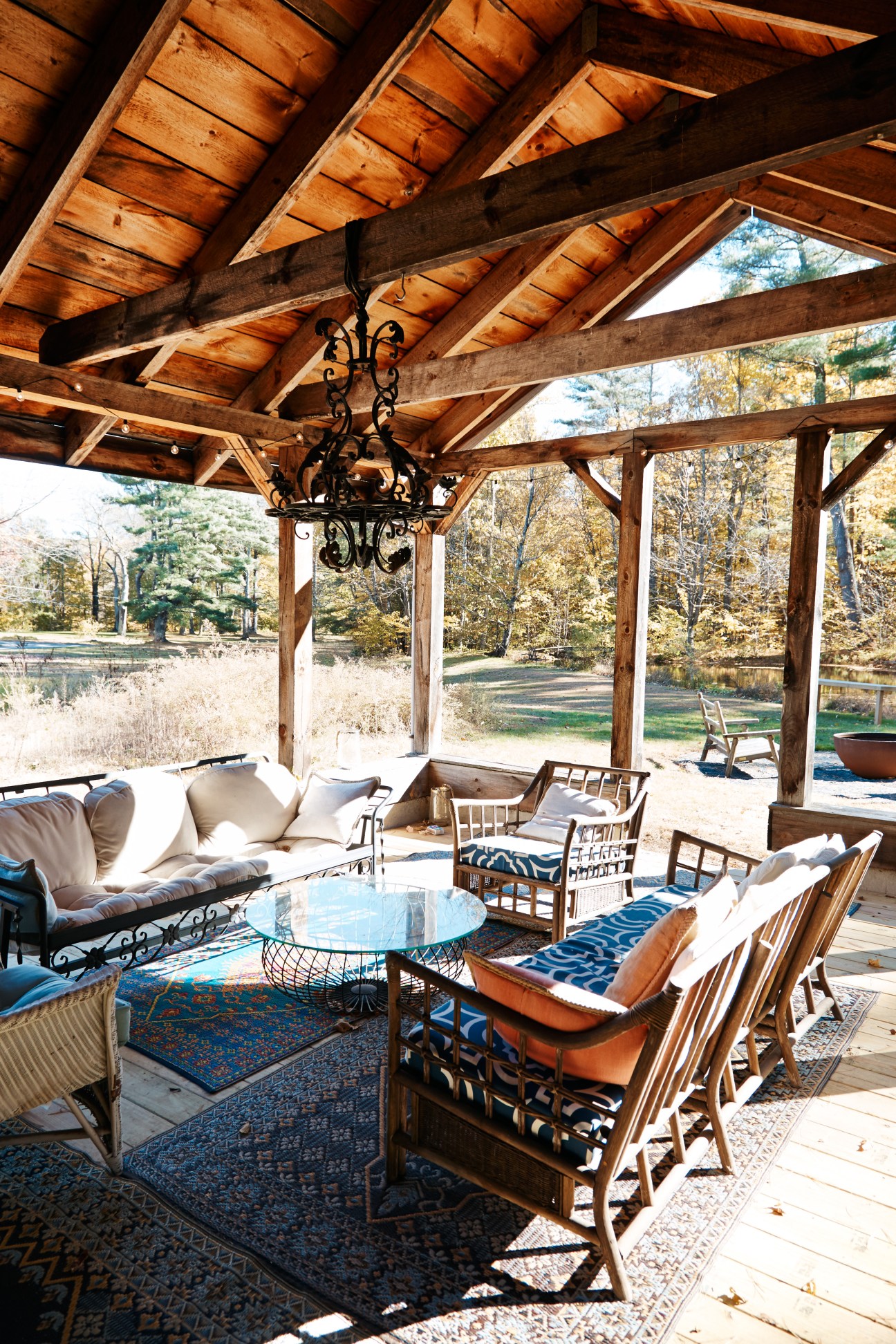 Wooden pergola with wrought-iron chandelier over seating area at Foxfire Mountain House.