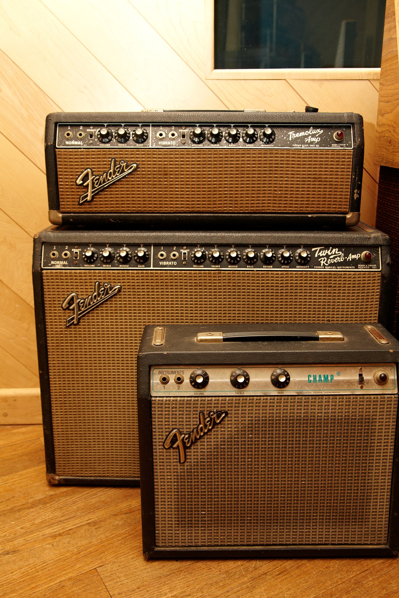 Stacked Fender guitar amplifiers in a studio setting.