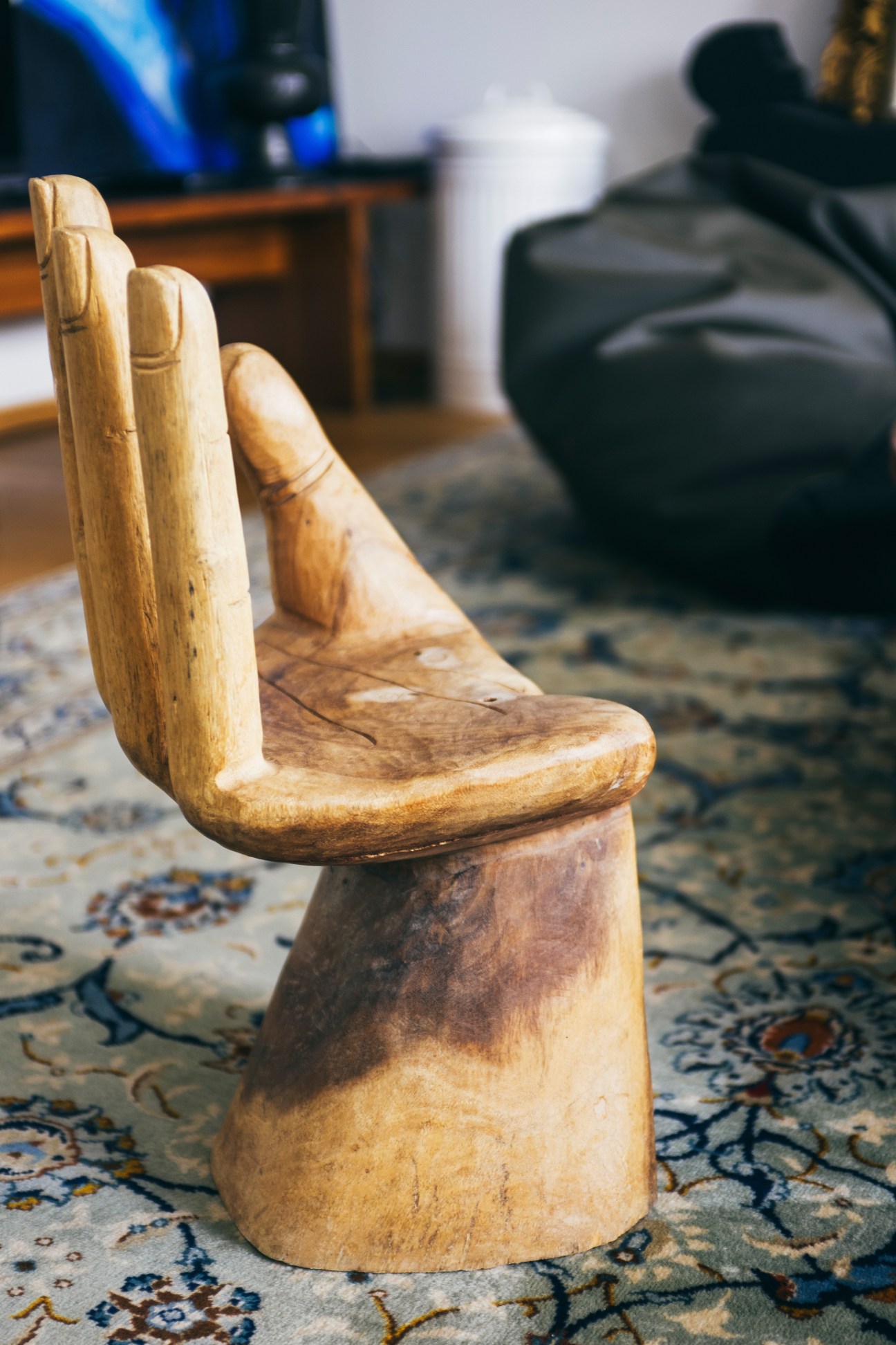 Wooden carved chair with hand-shaped back in architect Eugenijus Juozapavicius's flat.