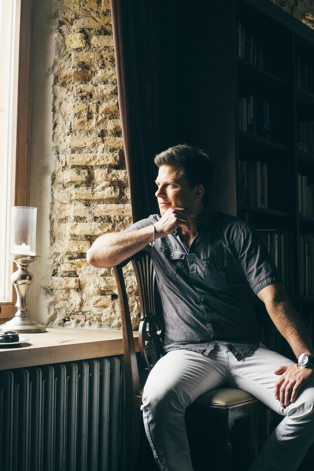 Darius Udrys, a branding consultant, sits by a window in his Uzupis apartment.