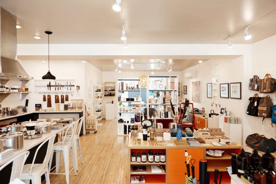 Interior of Valley Variety shop with wooden floors, white shelving, and curated home goods and accessories.