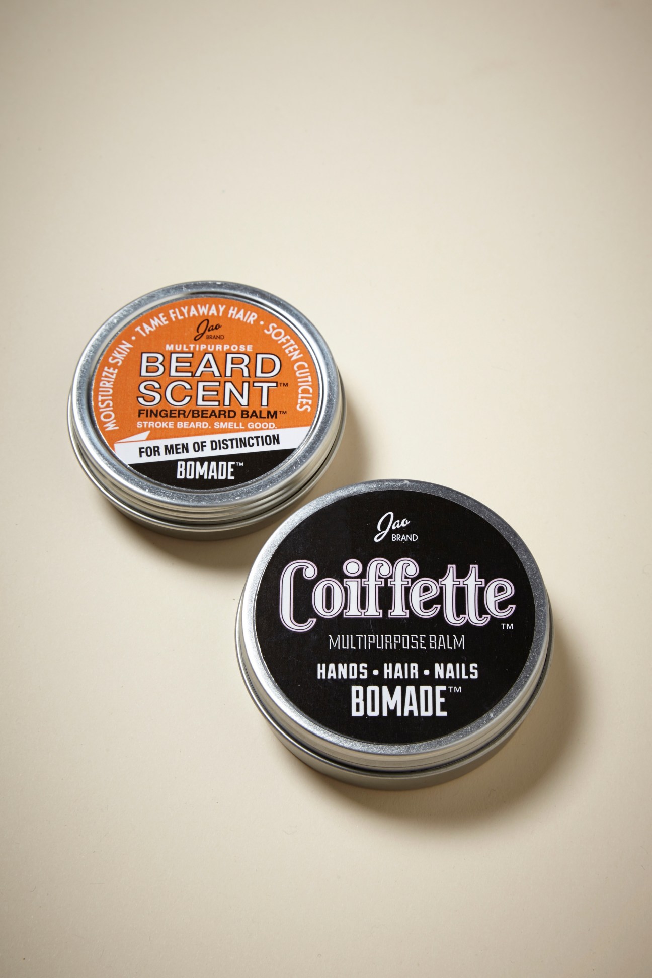 Two Jao Brand grooming products: an orange-labeled beard scent balm and a black-labeled Coiffette multipurpose balm.