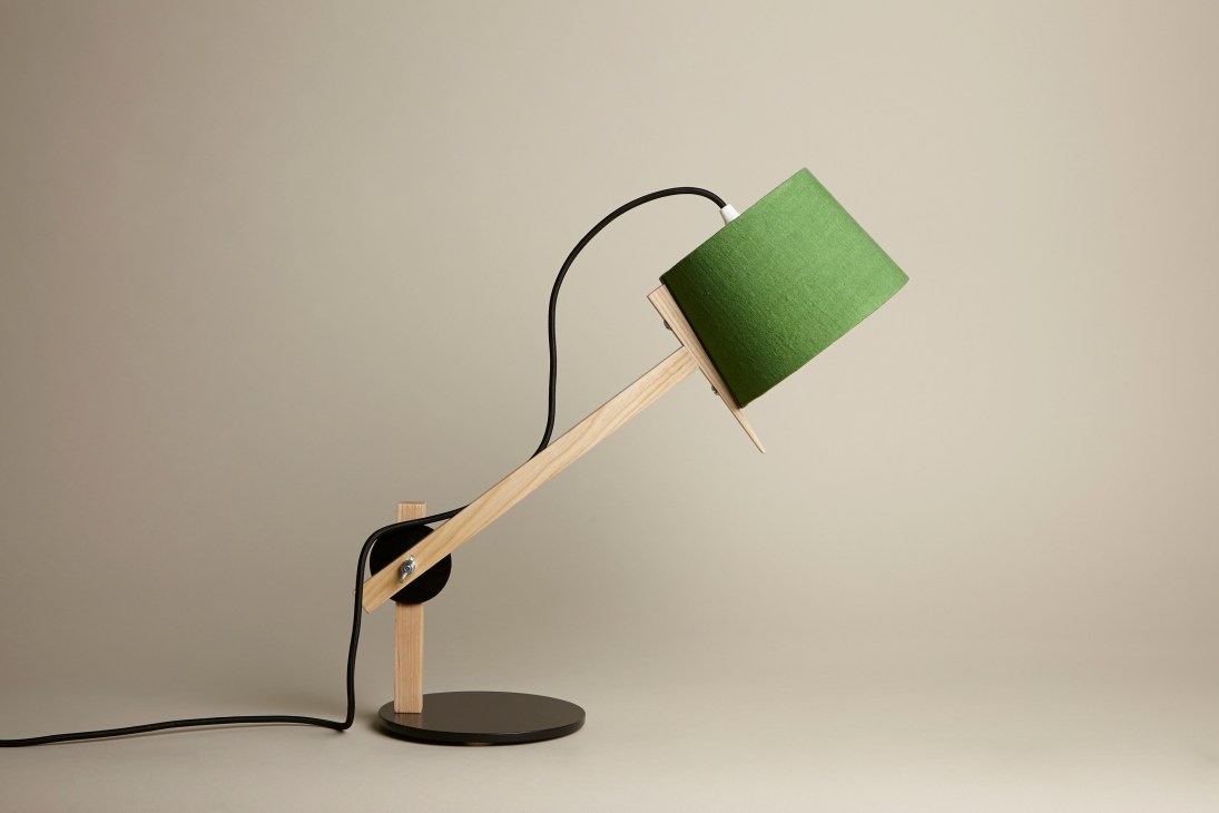 Douglas + Bec's Angle Table Lamp 2.0 with green fabric shade, wooden arm, and black base on neutral background.