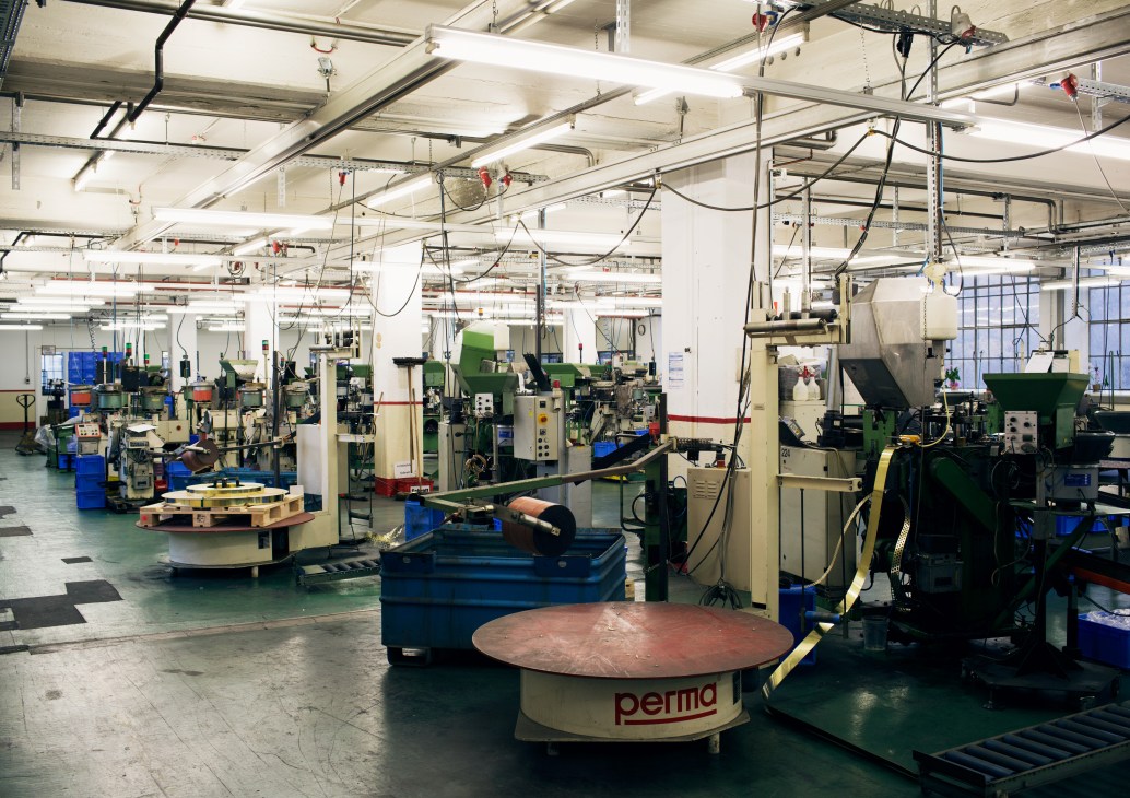 Prym's factory floor with industrial machinery for snap button production in Stolberg, Germany.