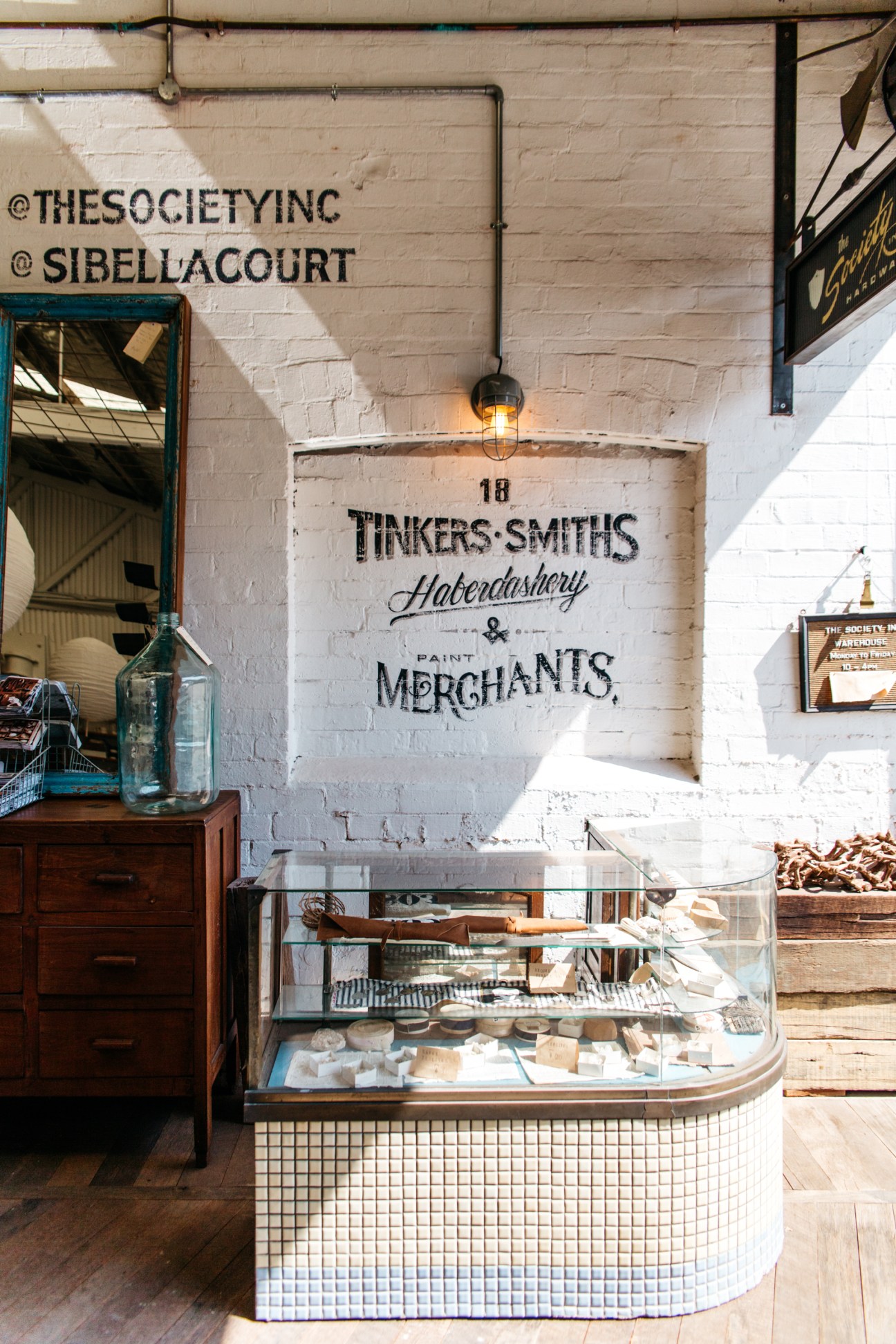 Interior of The Society Inc shop showing vintage signage and display counter with maritime-inspired decor
