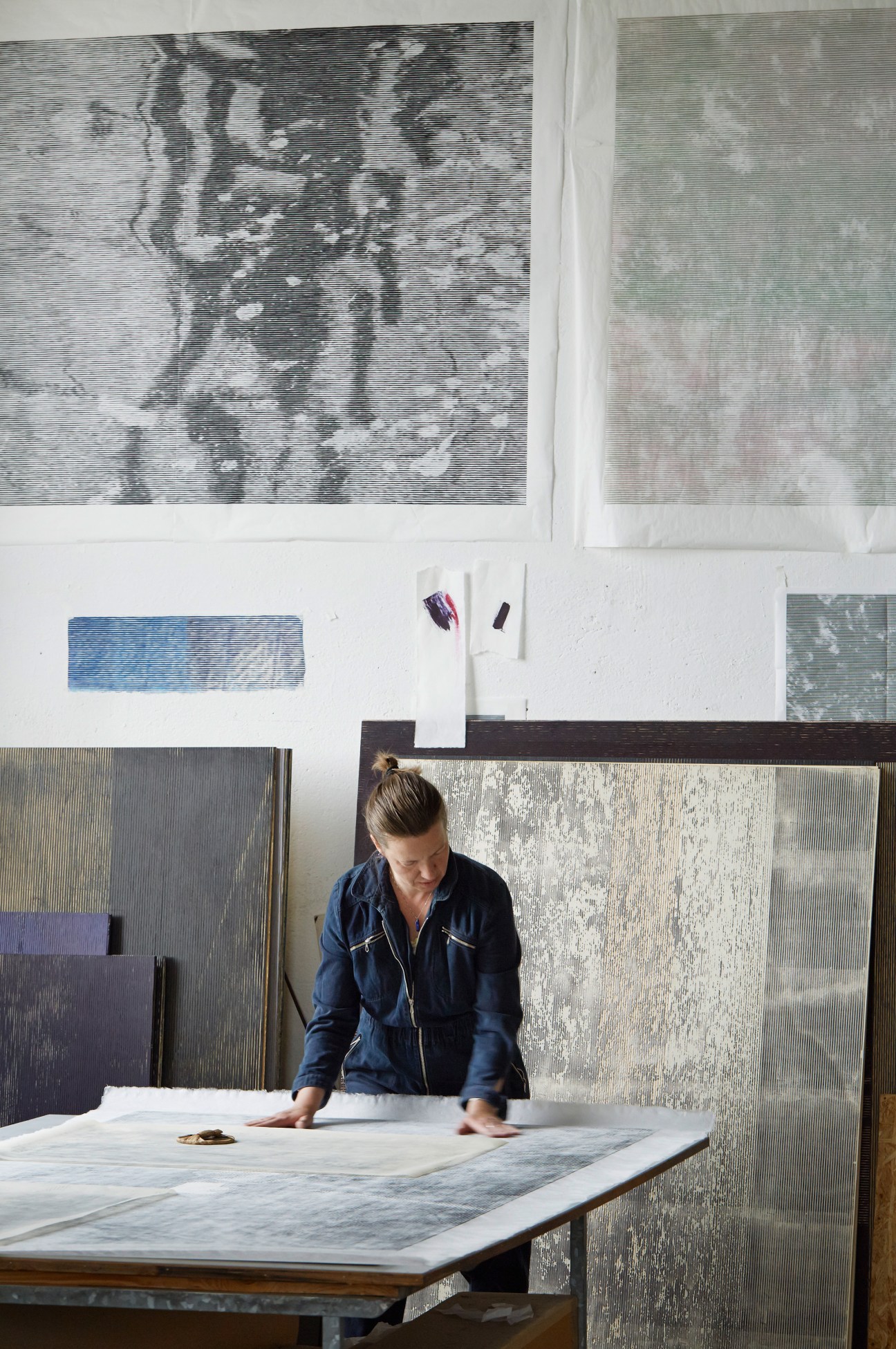 Christiane Baumgartner working with woodcut forms in her light-filled studio at the Spinnerei in Leipzig.