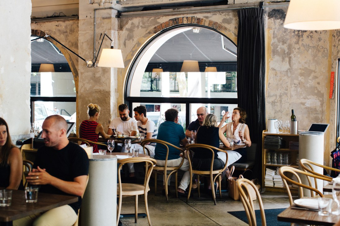 Diners seated at tables during busy lunch service at The Apollo restaurant in Potts Point.