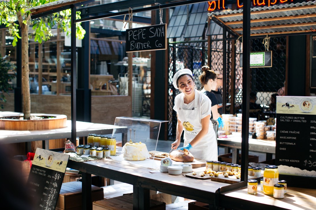 Pepe Saya butter vendor at market stall with samples and products on display