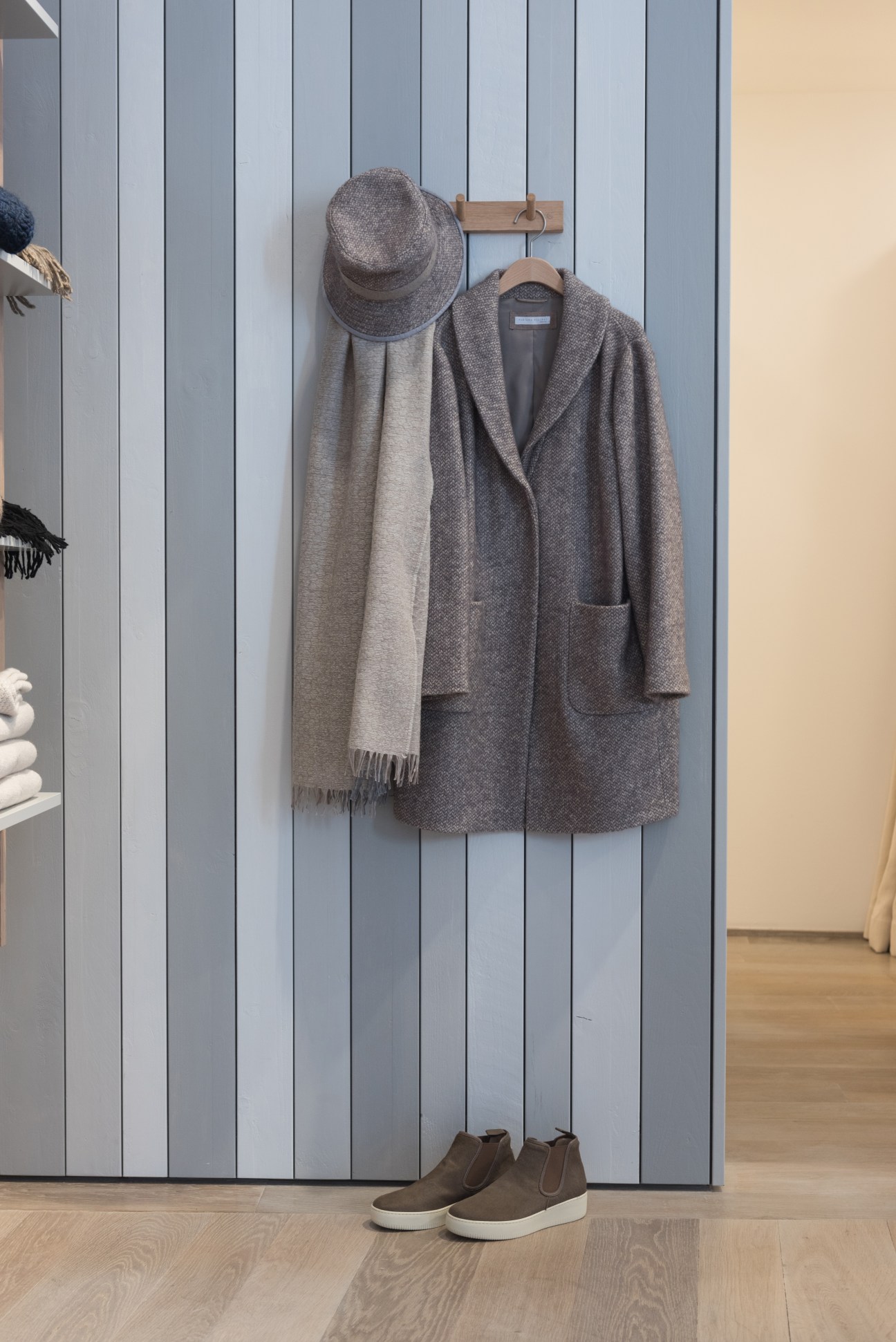 Fabiana Filippi coat and scarf displayed on wooden hanger with brown suede shoes below.