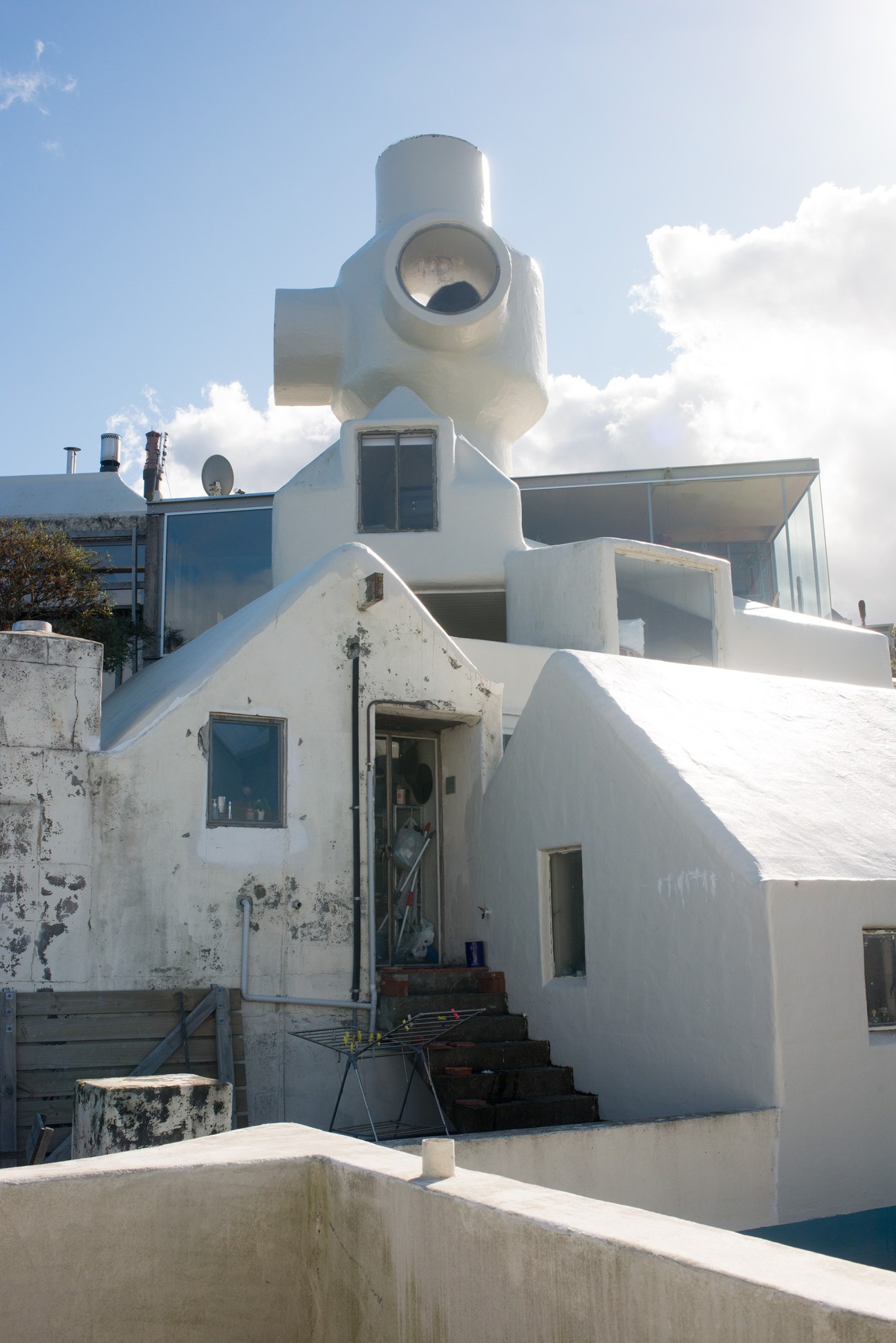 White modernist building with cylindrical tower element and geometric forms, Athfield Architects offices.