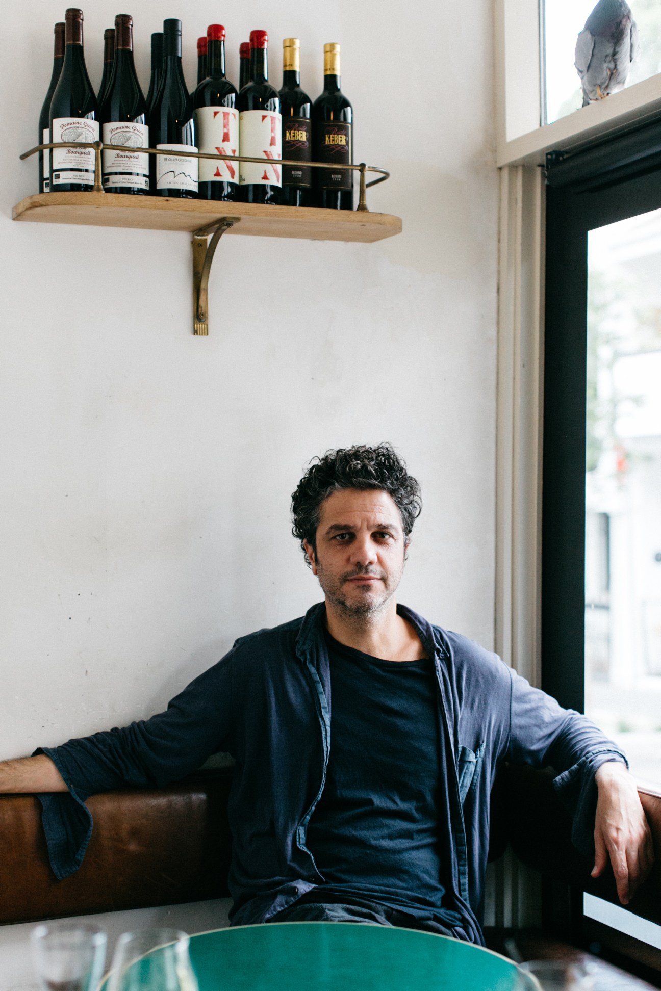Giovanni Paradiso, owner of 10 William Street restaurant, sitting by a wine shelf in his bistro.