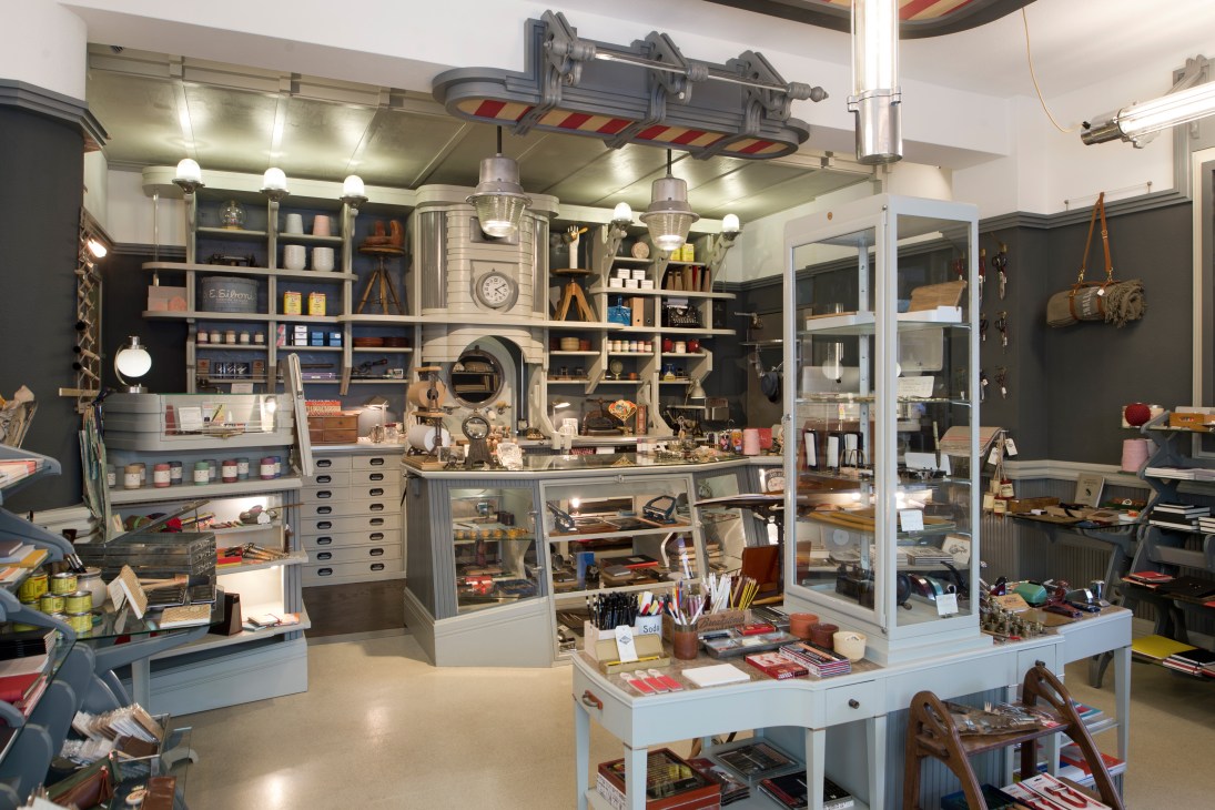 Fabrikat shop interior with shelving, craft supplies, vintage equipment and a metal central display unit.