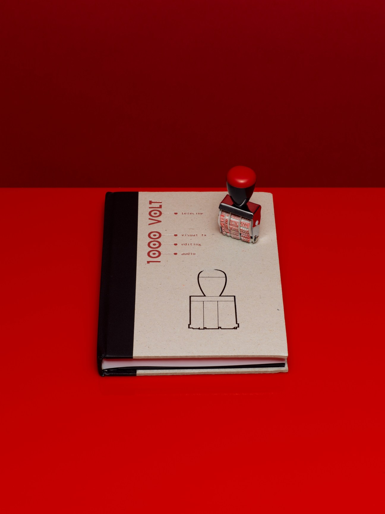 1000 Volt notebook agenda with red stamp on bright red background
