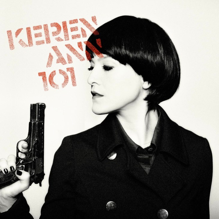 Black and white portrait of woman with short dark hair holding a handgun, with red glittery text reading 'KEREN ANN 101' above.