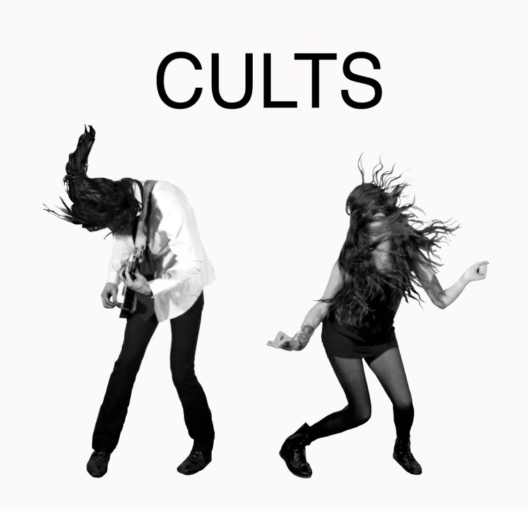 Black and white album cover for Cults showing two people with long hair jumping against white background