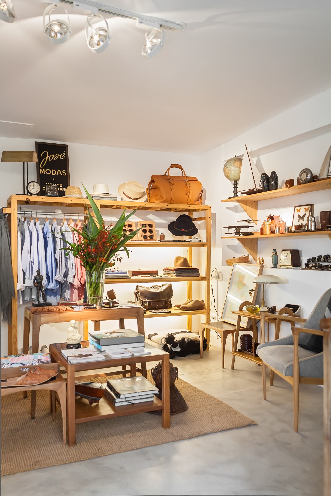 Interior of Mutate boutique with wooden shelving displaying clothing, accessories, and curated objects.