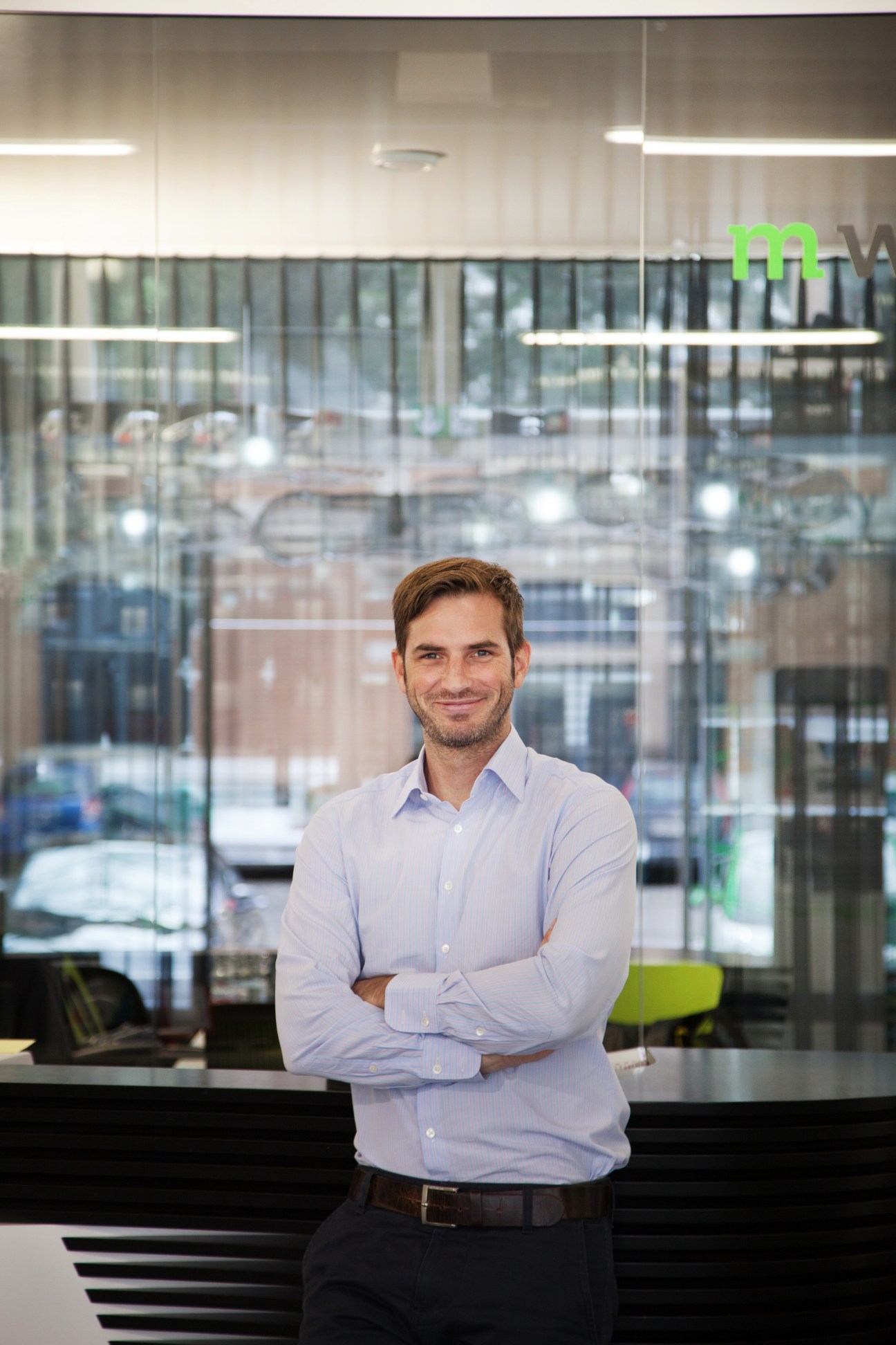 Hans-Jörg Dohrmann, M-way CEO, stands in the e-bike retailer's modern glass-fronted Zürich showroom.
