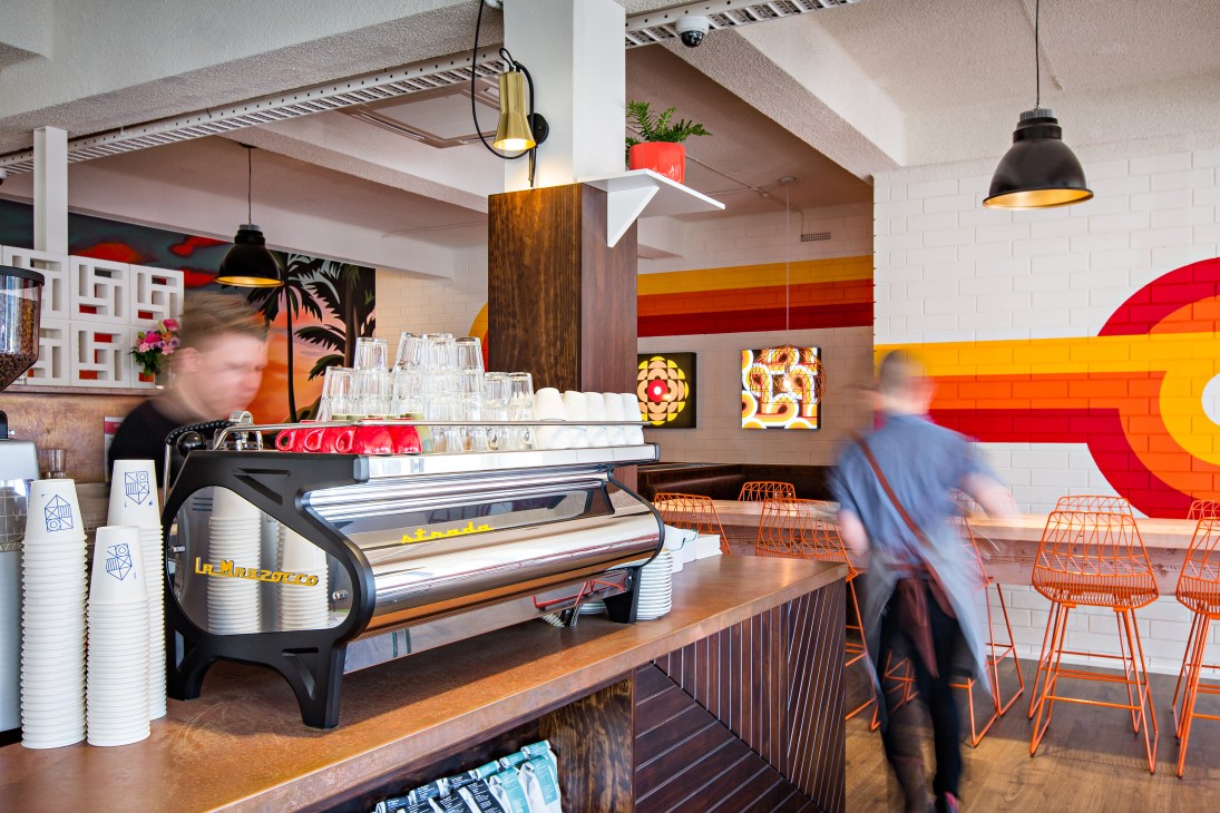 My Kingdom for a Horse café interior with espresso machine, orange chairs, and 1970s-inspired design in Adelaide.