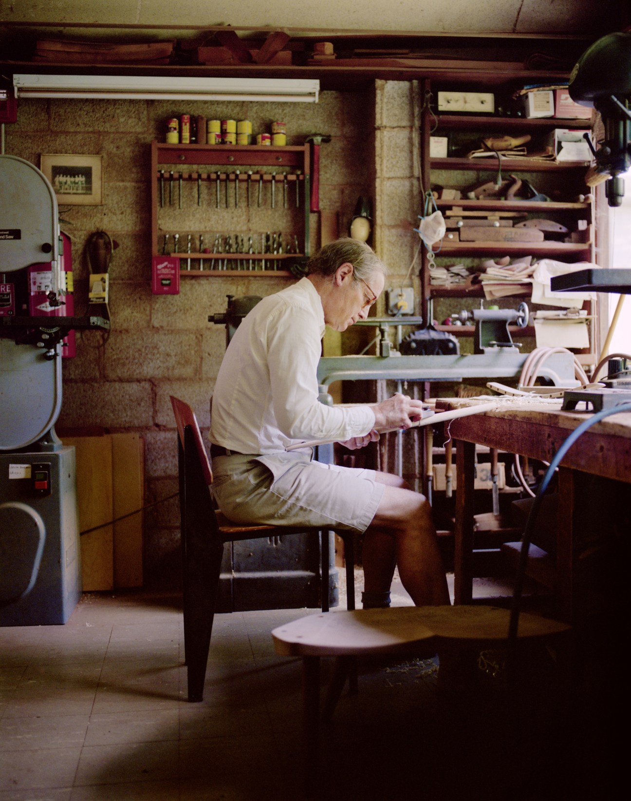 John Yarnall works on wood furniture in the Nakashima chair shop workshop.