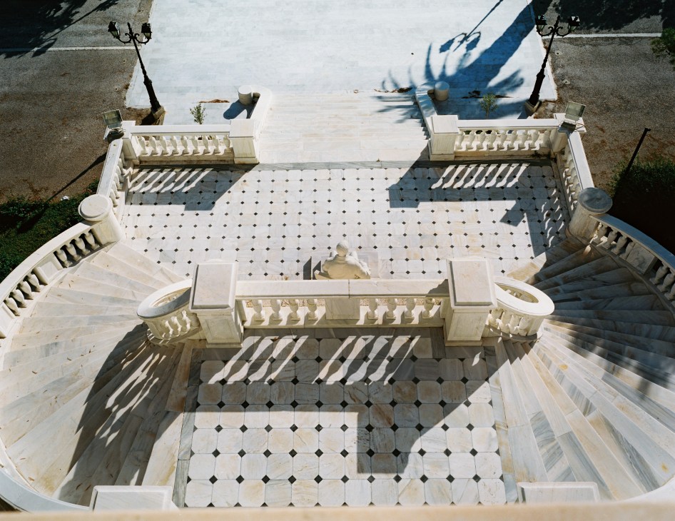Overhead view of Piraeus naval academy courtyard with white marble floors and classical architecture.