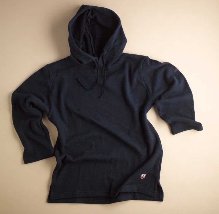 Navy blue hooded sweater displayed flat on a beige background.