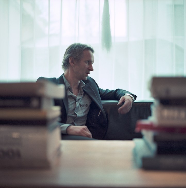 Jon Kaldal, editor in chief of Frettabladid newspaper, sitting by a window in an office