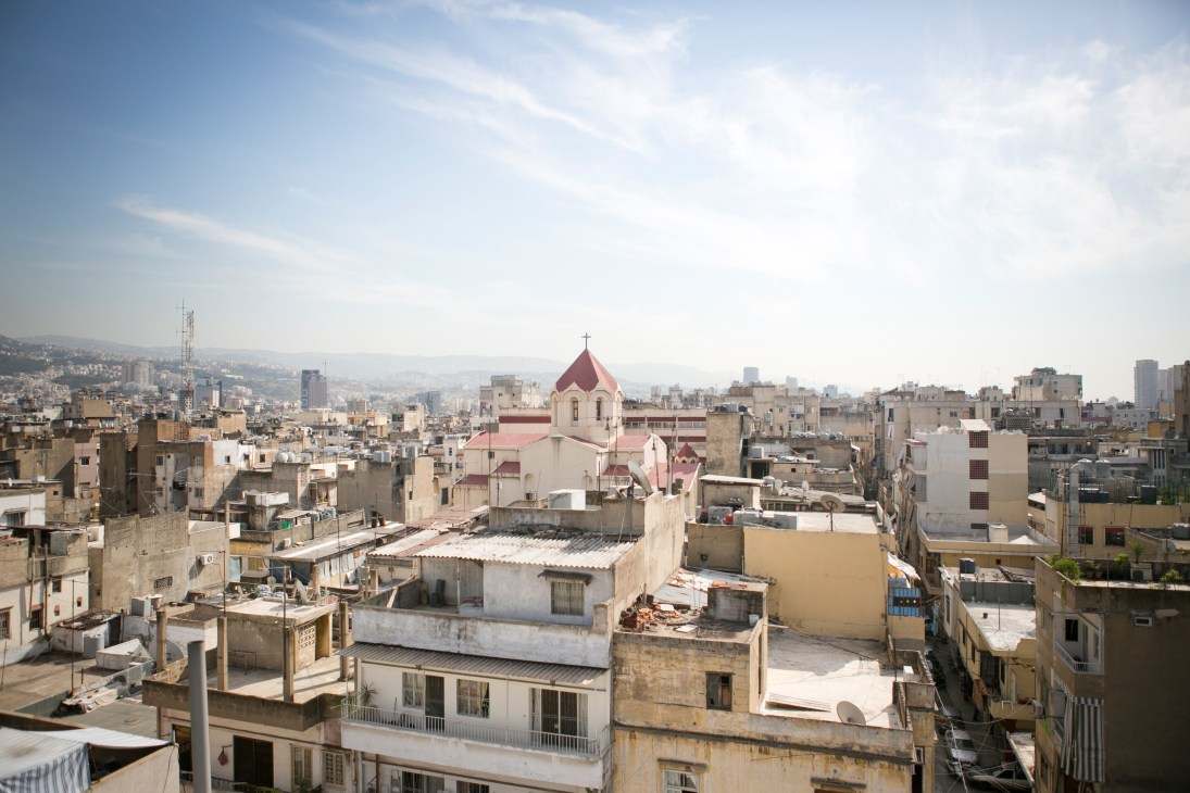 Aerial view of Bourj Hammoud neighbourhood in Beirut with dense residential buildings and an Armenian church with red dome.