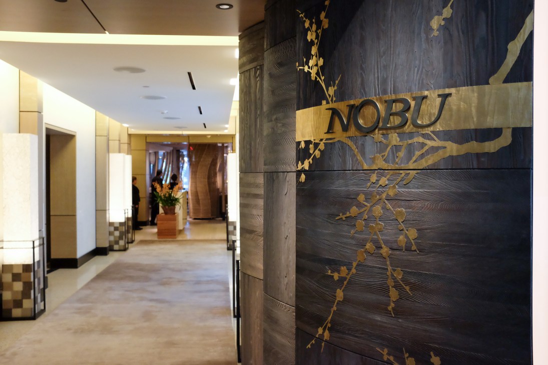 Entrance to Nobu restaurant at Eden Roc Hotel with illuminated signage and Japanese-inspired décor.