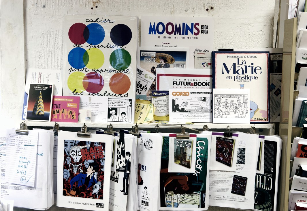 SelfMadeHero publishing materials and graphic novels displayed on a studio wall.