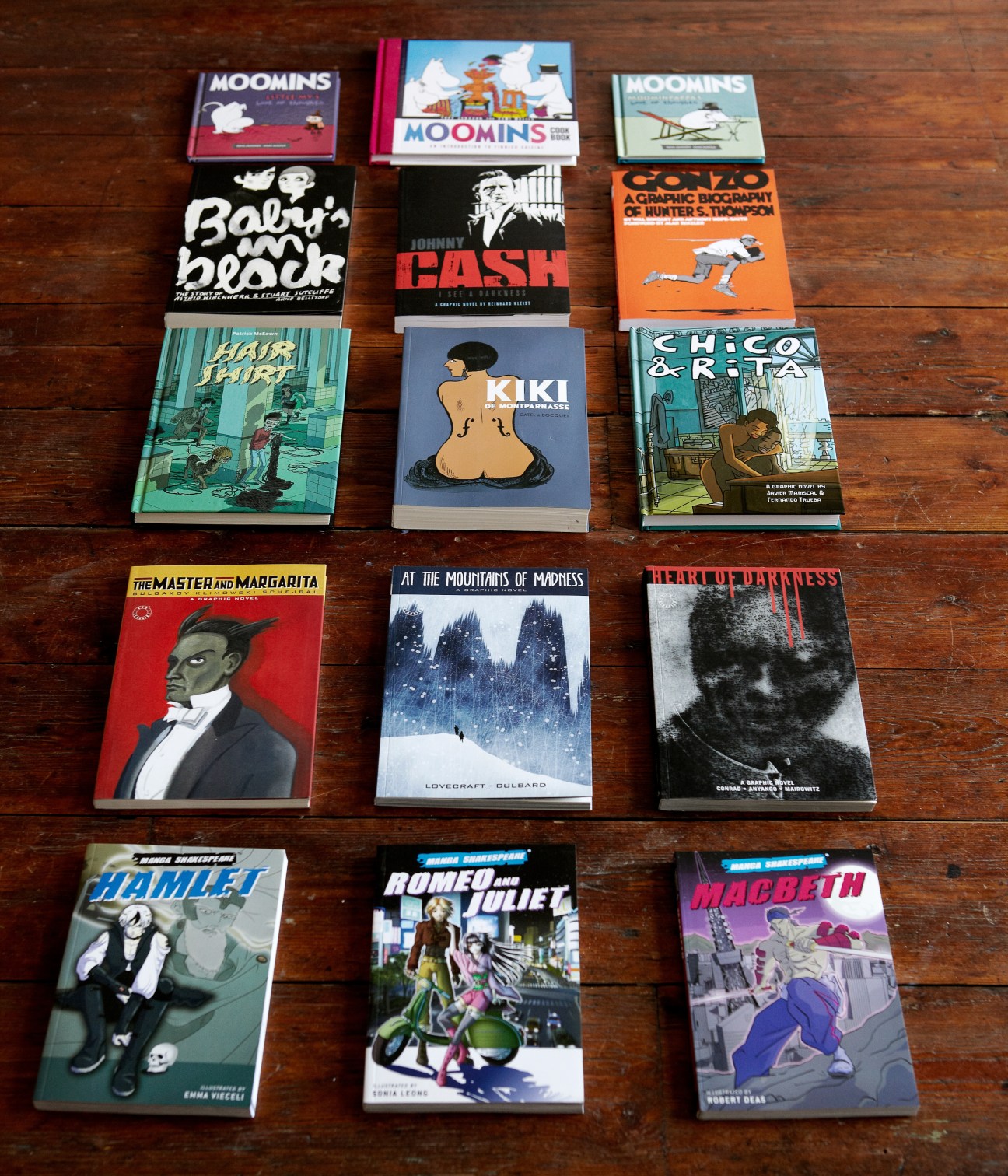 Collection of SelfMadeHero graphic novels arranged on wooden surface, including Manga Shakespeare titles and literary adaptations.