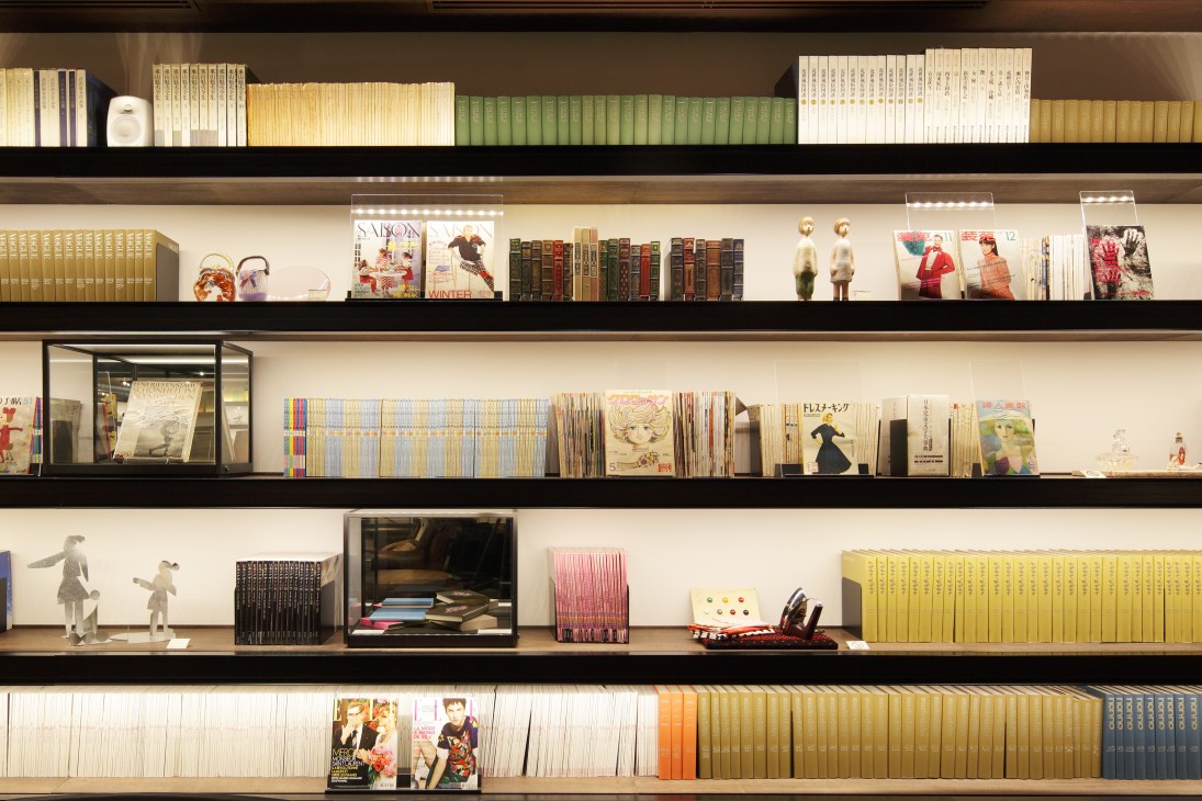 Shelving displays books, magazines, and art objects organized by color and category at Tsutaya Books.