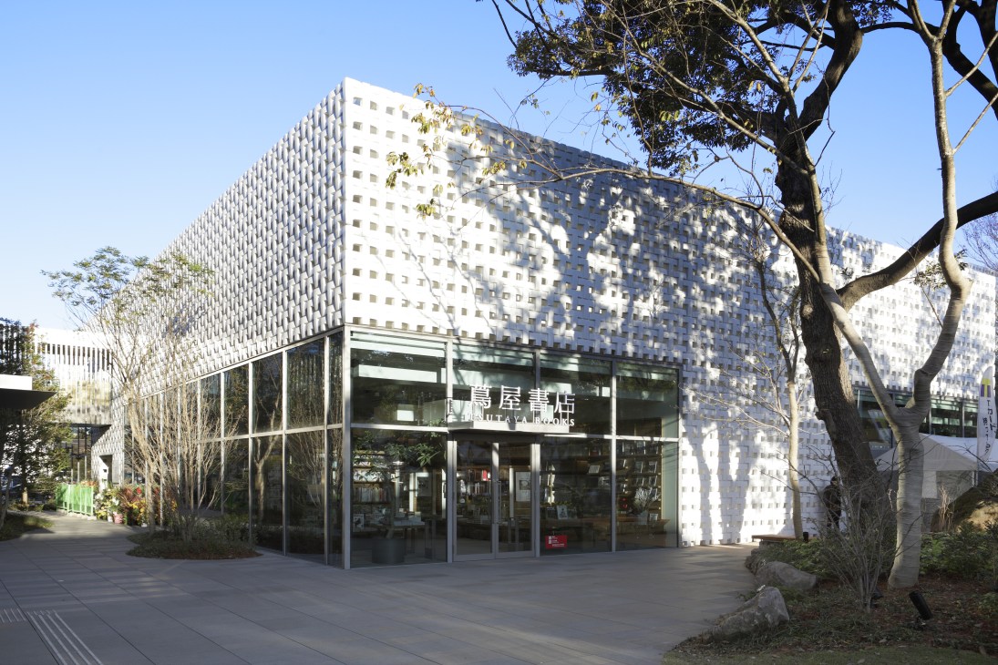 Exterior of Tsutaya Books in Tokyo's Daikanyama district, designed by Klein Dytham architecture, featuring white perforated facade and glass entrance.