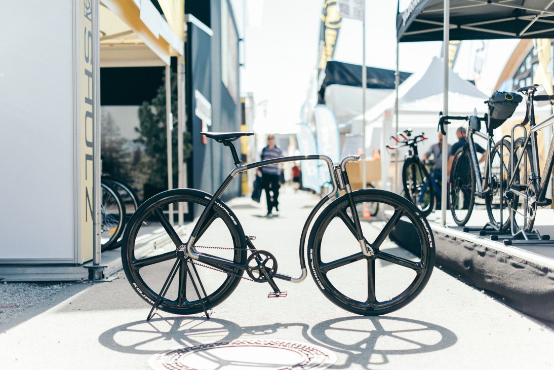 Black fixed-gear bicycle with large disc wheels displayed at Eurobike trade fair
