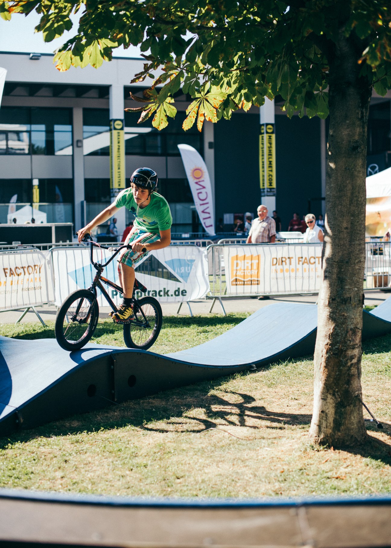 Cyclist riding a bike with small wheels on a modular pumptrack course at Eurobike trade fair.